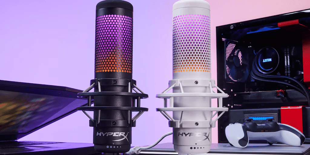 A black and white HyperX gaming microphone with RGB lighting displayed on a desk with a computer setup in the background.RetryClaude can make mistakes. Please double-check responses.